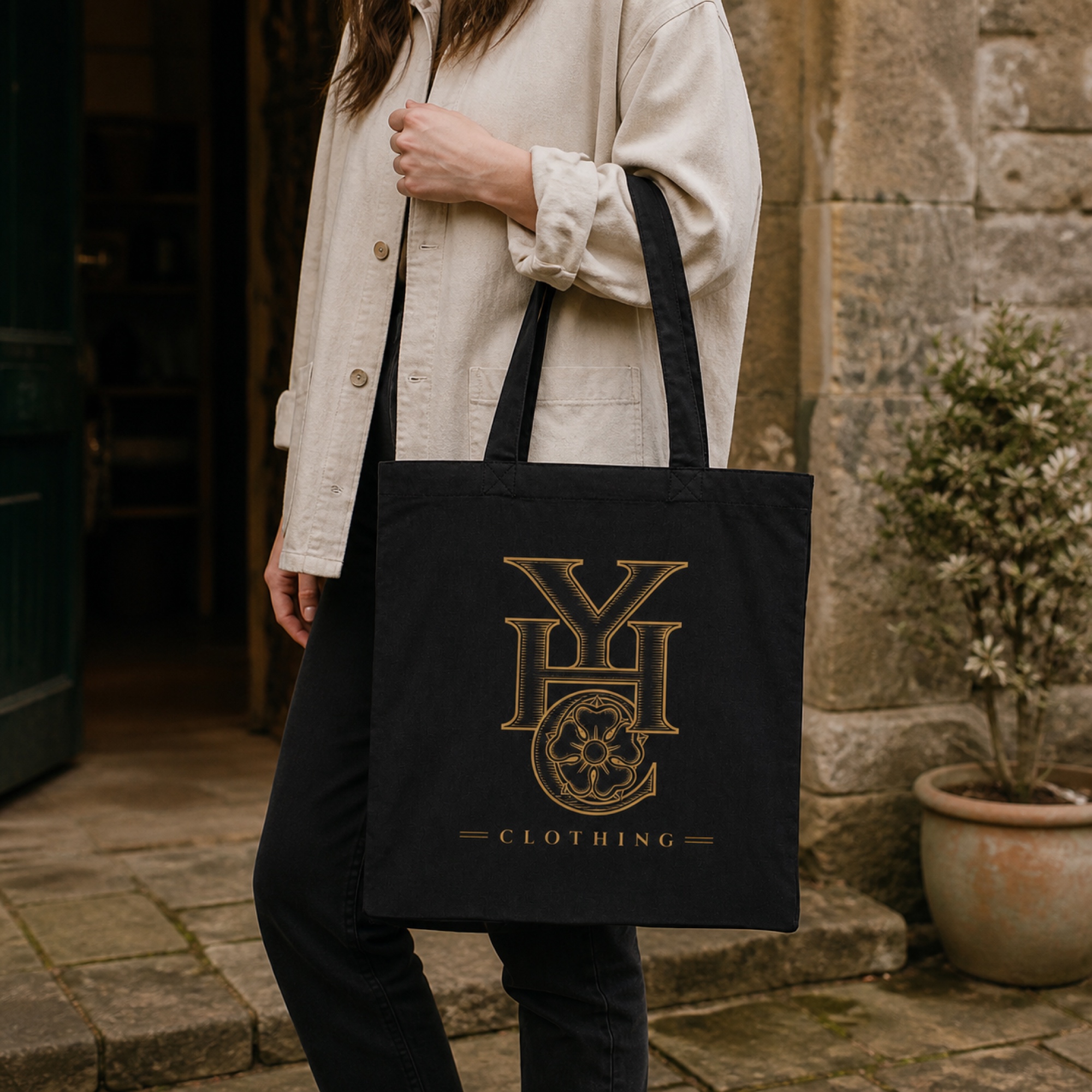 True Black Yorkshire Heart Clothing recycled cotton Mid Tote carried outside a Yorkshire stone building